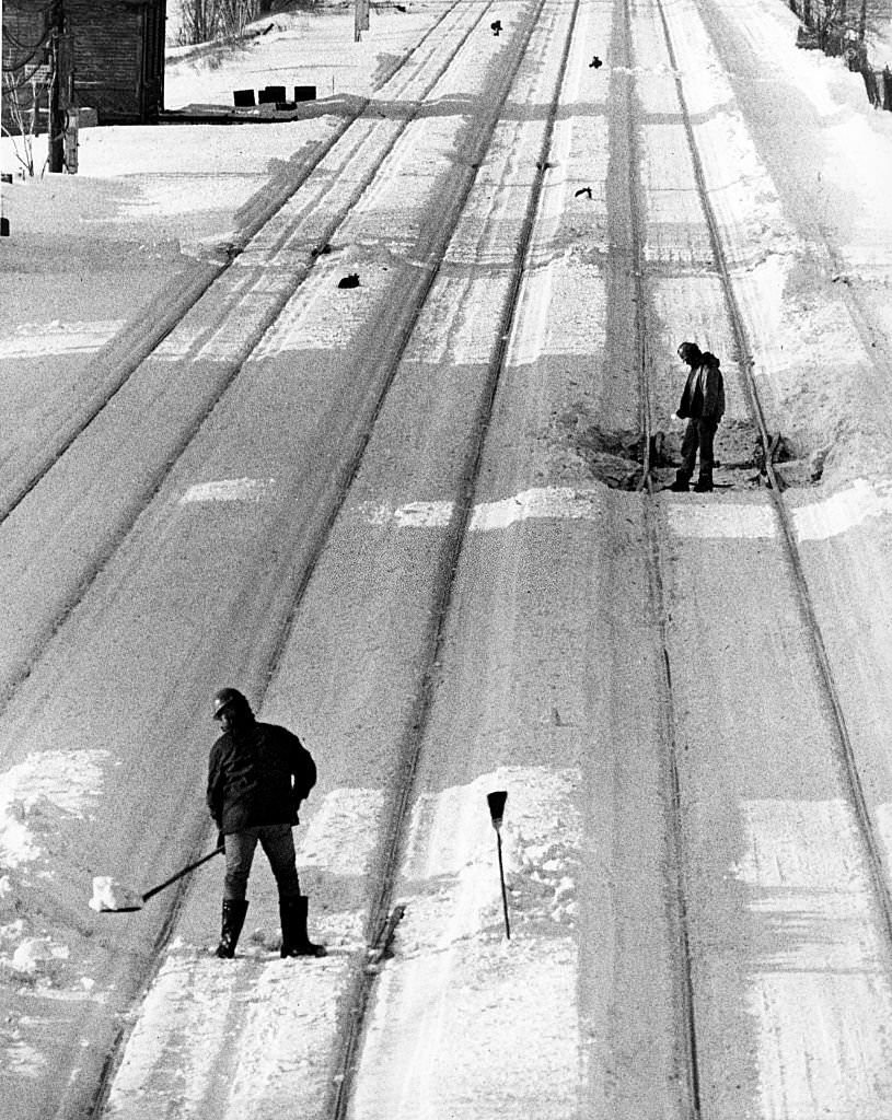 Workers maintenance railroad tracks near Massachusetts Avenue on Jan. 23, 1978, three days after a blizzard that dropped 21.4 inches of snow on the city.