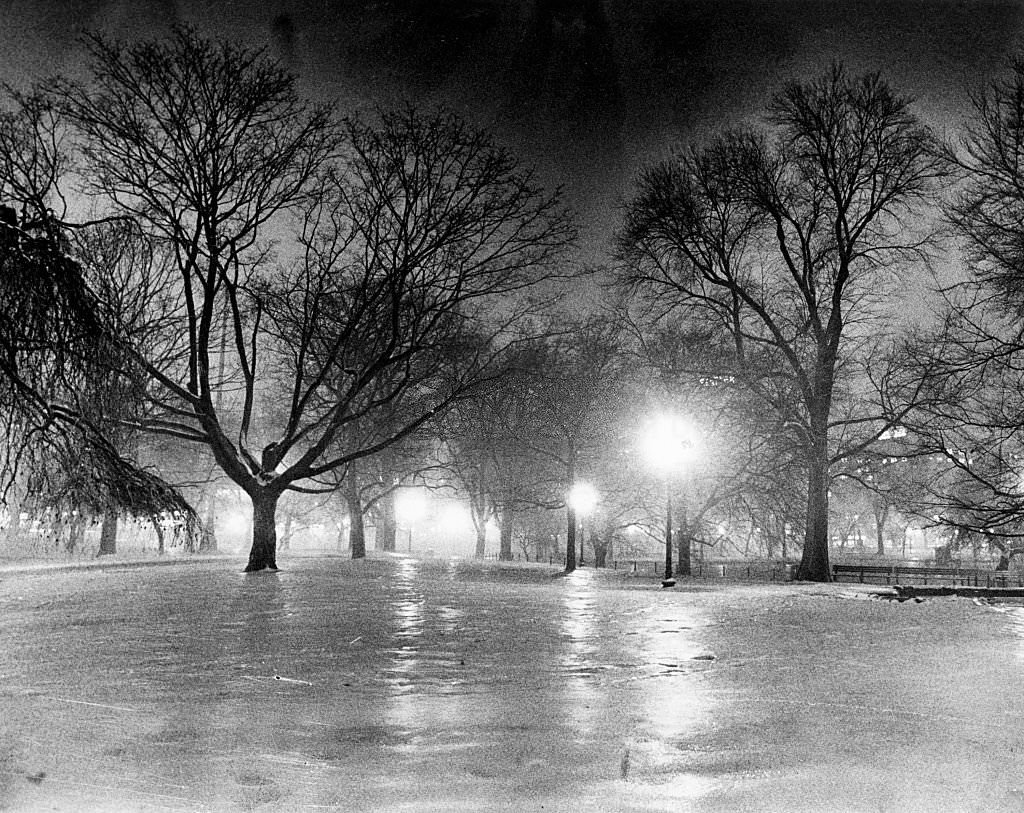 Boston's Public Garden is covered in snow and ice at night, 1977.