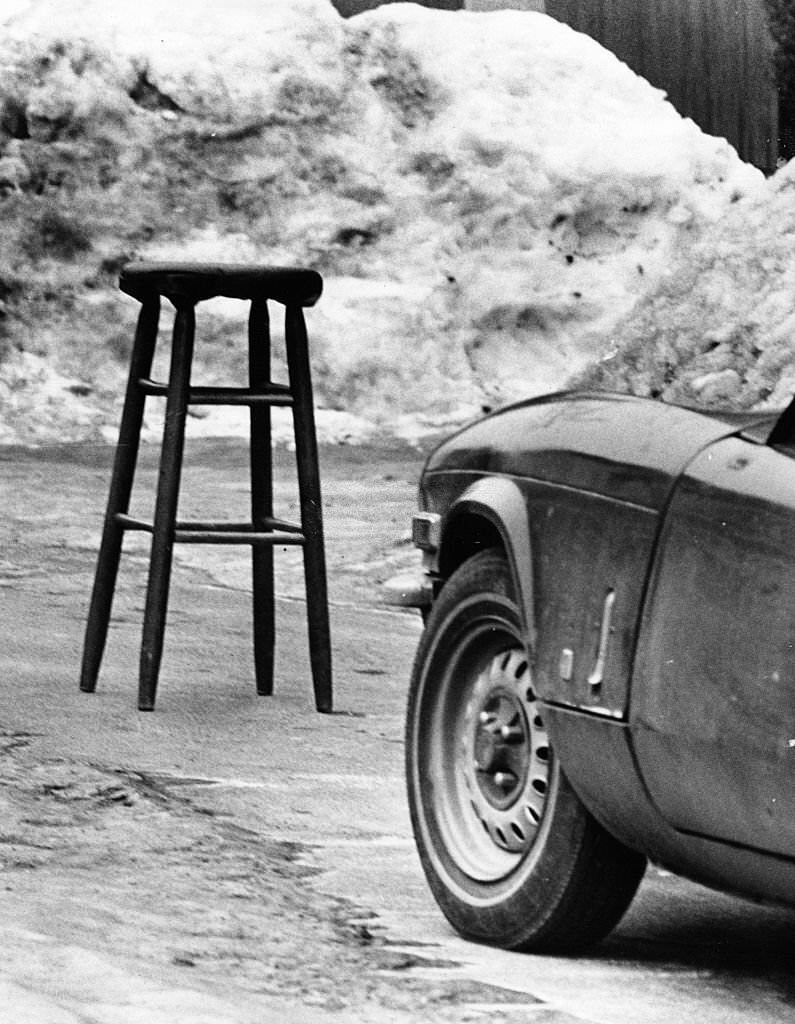 A stool saves a parking spot on a snowy Marine Street in South Boston, 1977.