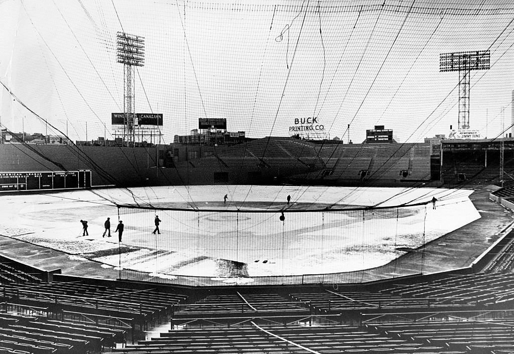 The grounds crew clears yesterday's snow off the playing field at Fenway Park in Boston, 1975.