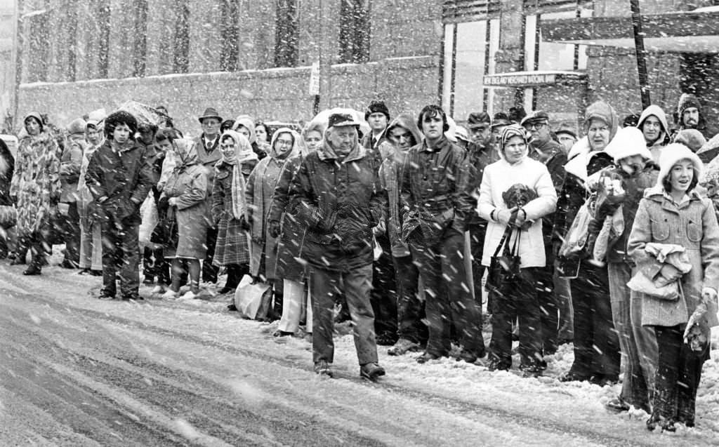 Commuters wait for the bus in the snow at South Station in Boston, 1975.