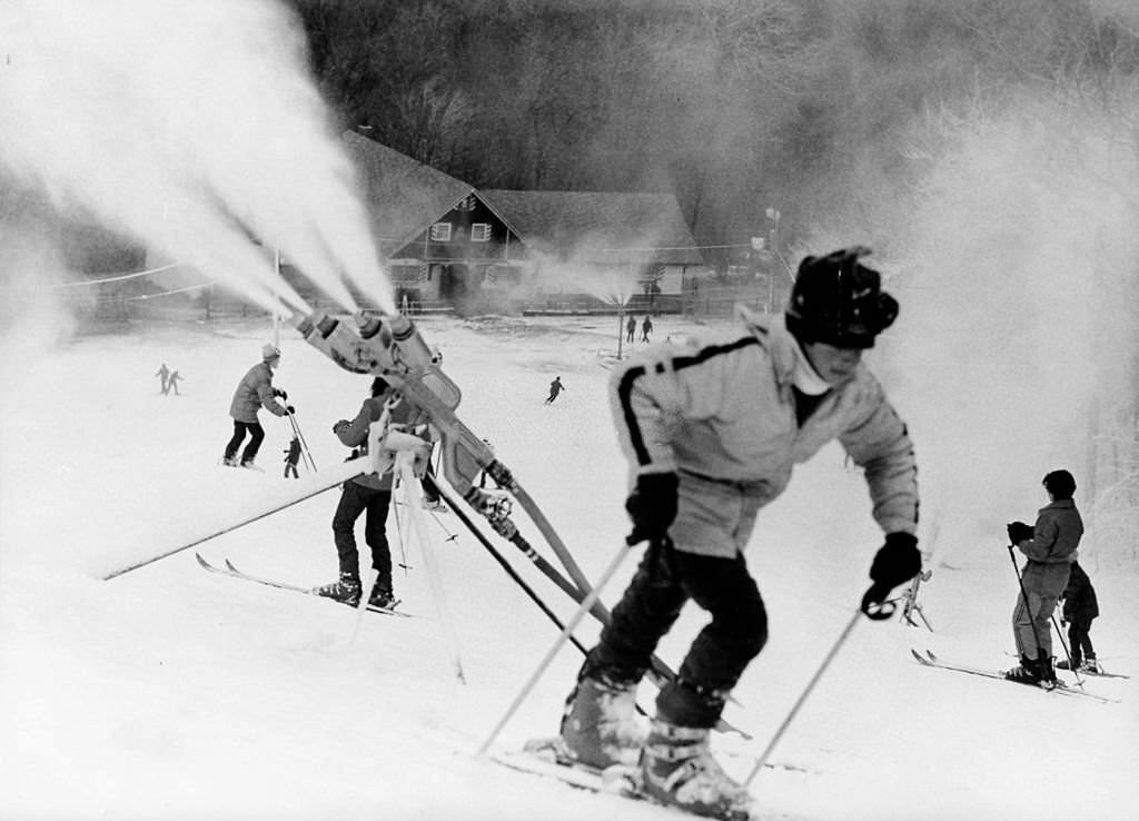 Peoples ski at Blue Hills Ski Area in Canton, 1974. Snow making machines are making snow.