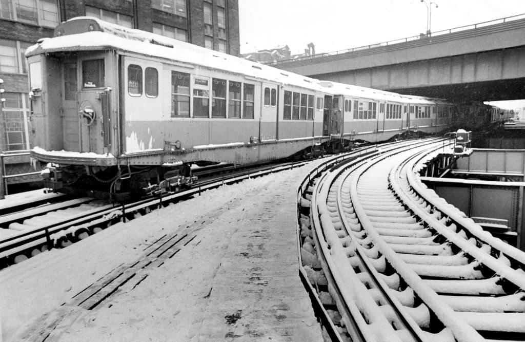 An MBTA train is pictured in December 1970 in Boston after a snow plow derailed on the Forest Hills to Everett line, making it necessary to run shuttle buses between North Station and Sullivan Square.