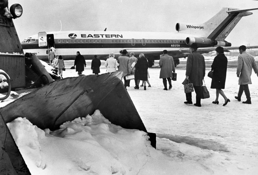 Passengers walk to the first plane to leave Logan International Airport in Boston for New York, 1969.