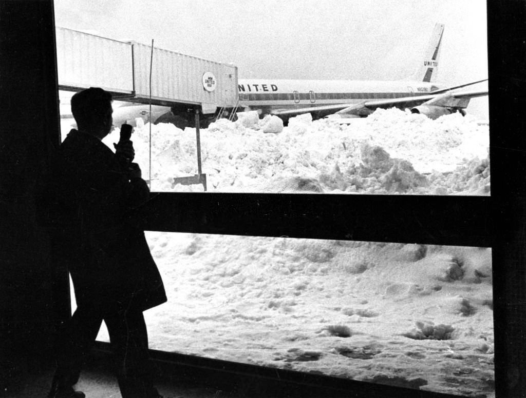 Snow is piled up next to a United Airlines plane at Logan Airport in Boston, 1969.