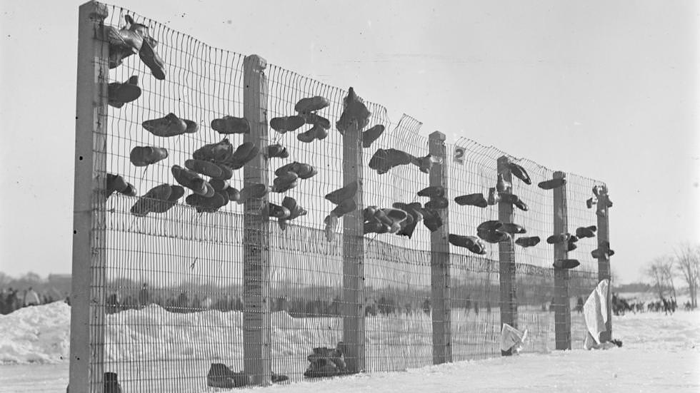 Skaters put up shoes in baseball backstop at Franklin Field, 1933