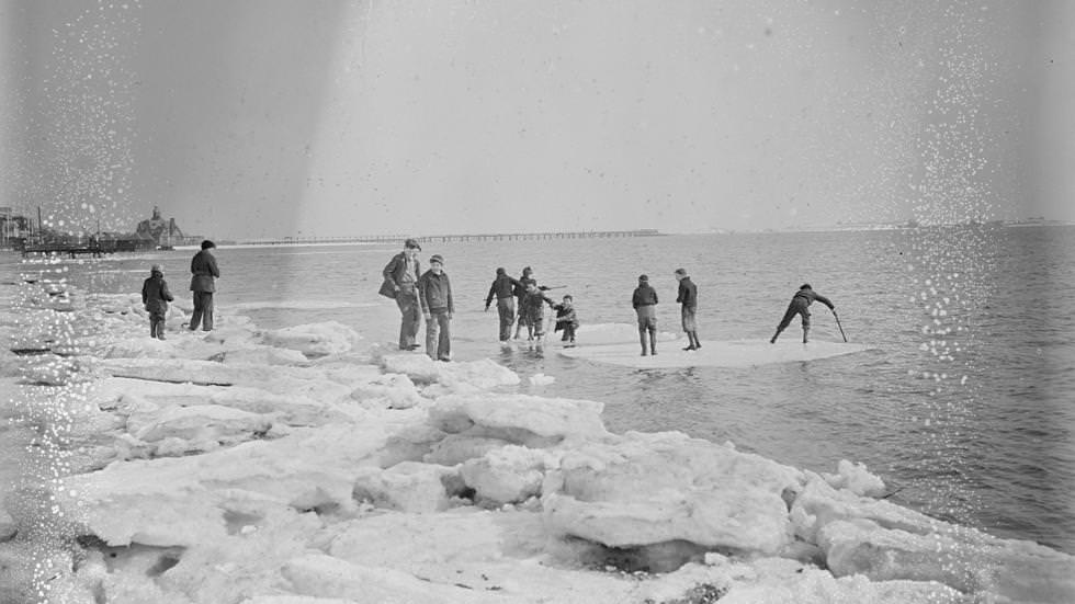 Boys riding ice cakes in Dorchester Bay, 1935