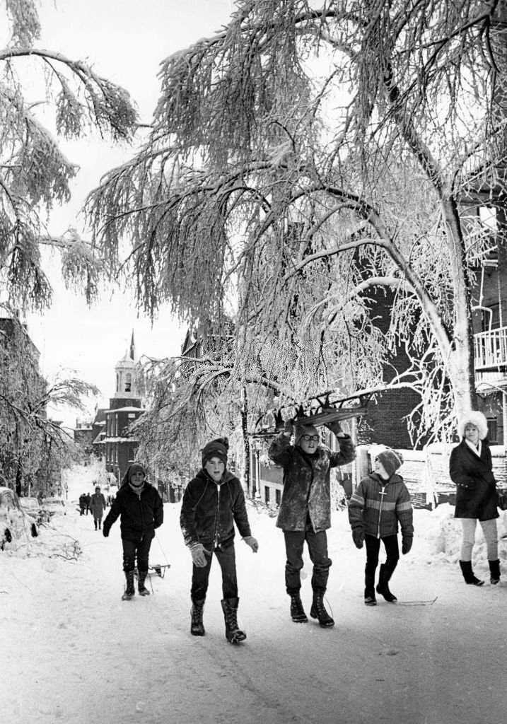 Children carry sleds down the streets of Beacon Hill neighborhood in Boston.