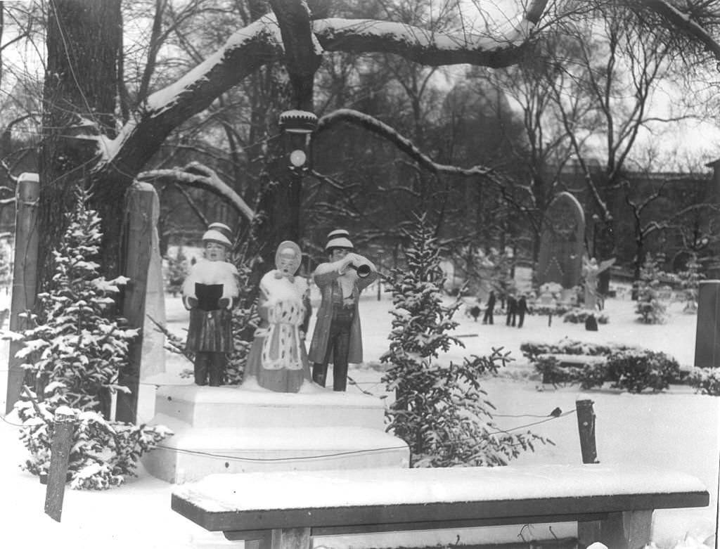 Snow blankets the display of carolers at the Boston Common after the early snow storm.