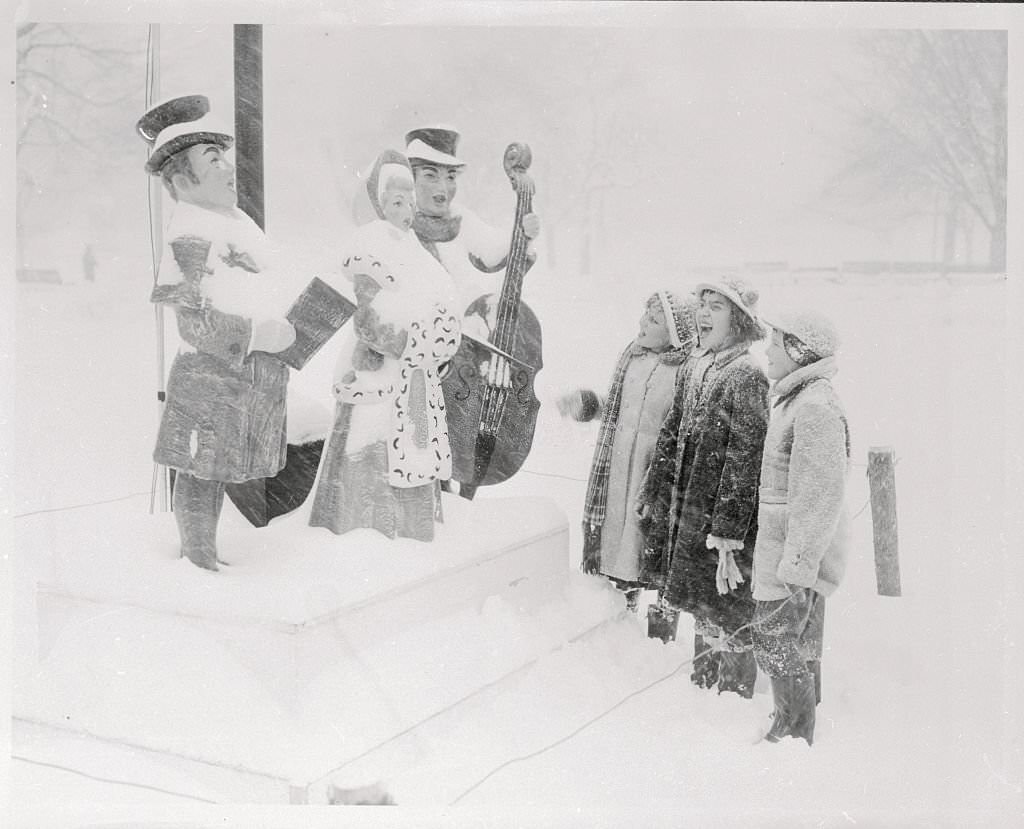 Three Boston youngsters join in a Christmas carol with three almost real singers (left) during the snowstorm.