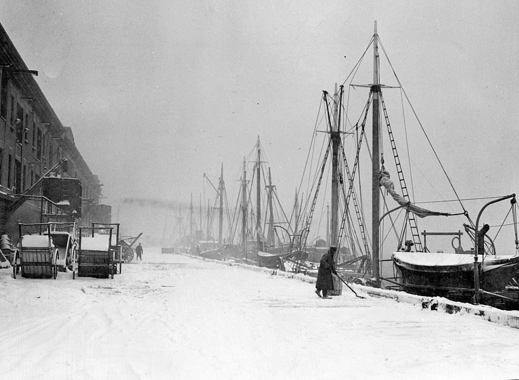 A man shovels snow off Fish Pier in Boston, February 1947.