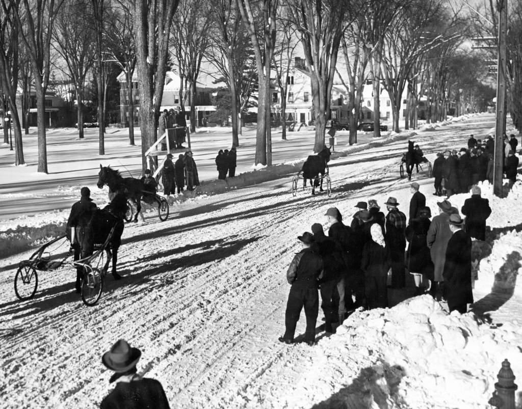 Two horse-drawn carts race towards the finish line in Lyndonville, Vt., February 1946.
