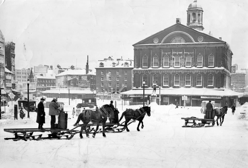 A horse drawn carriage moves through the snow passed Faneuil Hall after a 1945 winter storm.