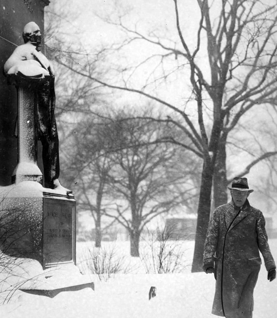 A man walks past the statue of Wendell Philips at the snow-covered Public Garden in Boston, 1936.
