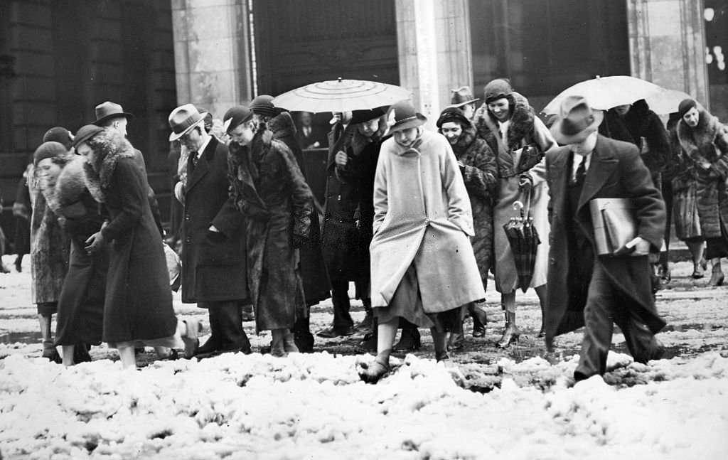 Pedestrians on their way to lunch cross through the slush at Congress and Water Streets in Boston at noon on April 13, 1933.