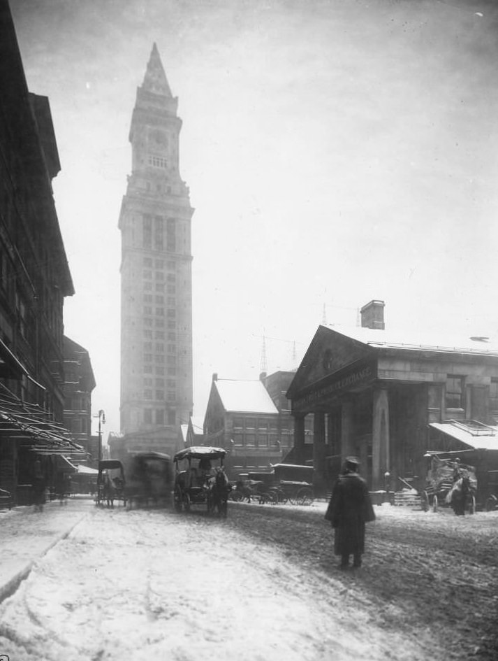 Boston's Custom House, several horse-drawn carriages on snowy street in foreground, Fruit and Produce Exchange on right, Boston, Massachusetts, 1906.