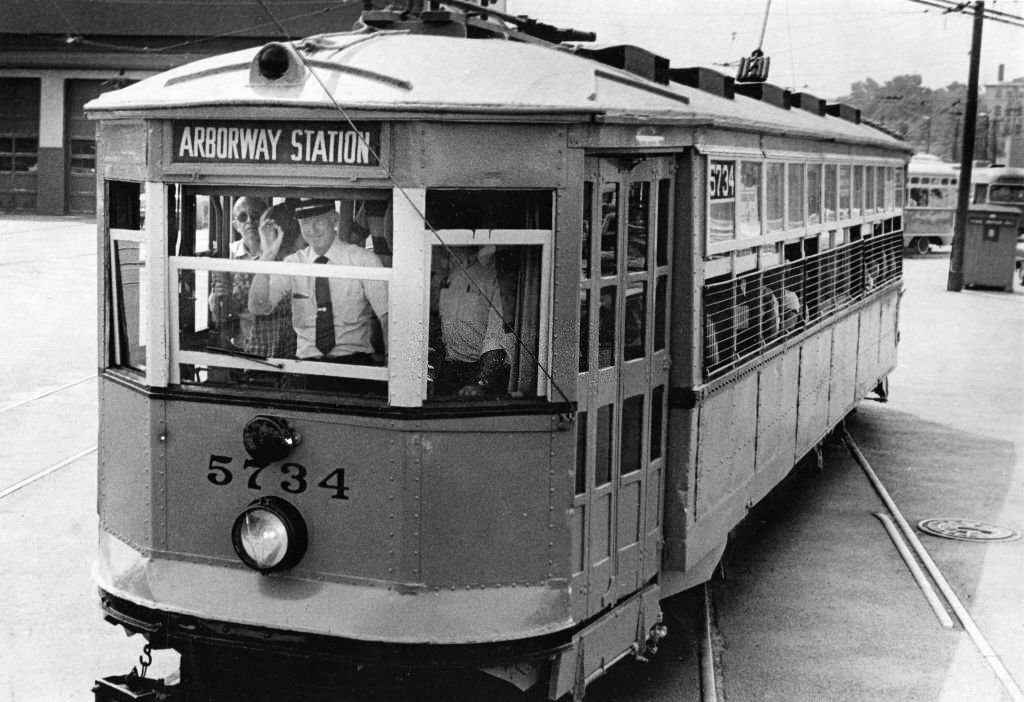 A vintage 1922 orange trolley car, filled with more than 100 transit fans, rides to Park St. Station from the Watertown car barn in Boston.