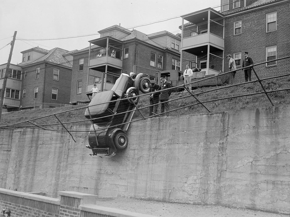 Fence keeps car from falling, Brookline, 1931