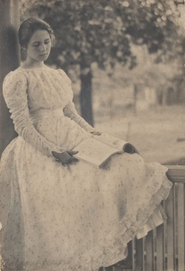 Woman seated on a porch railing, 1897