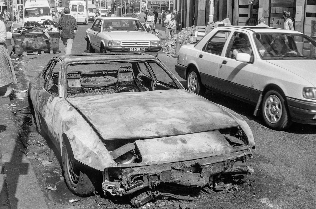 Burnt out car, St Martin’s Lane, Covent Garden, Westminster, 1990