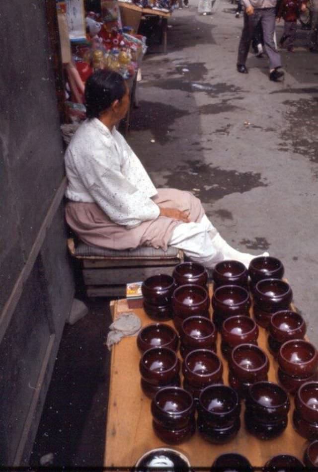 Woman selling ceramic bowls, Tague, 1970s
