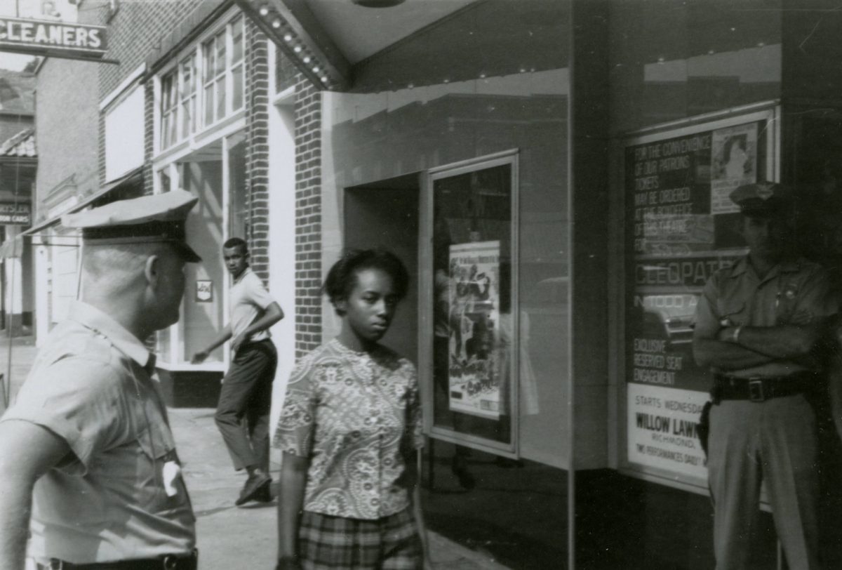 Gladys Lawson walking towards camera. L. Francis “Skip” Griffin, Jr. turning back towards camera. Eugene Overton at left.