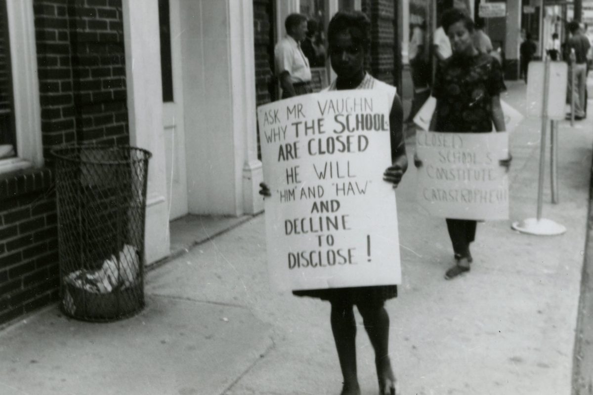 Phyllis Hicks, second in line, carries “Closed Schools…” sign.