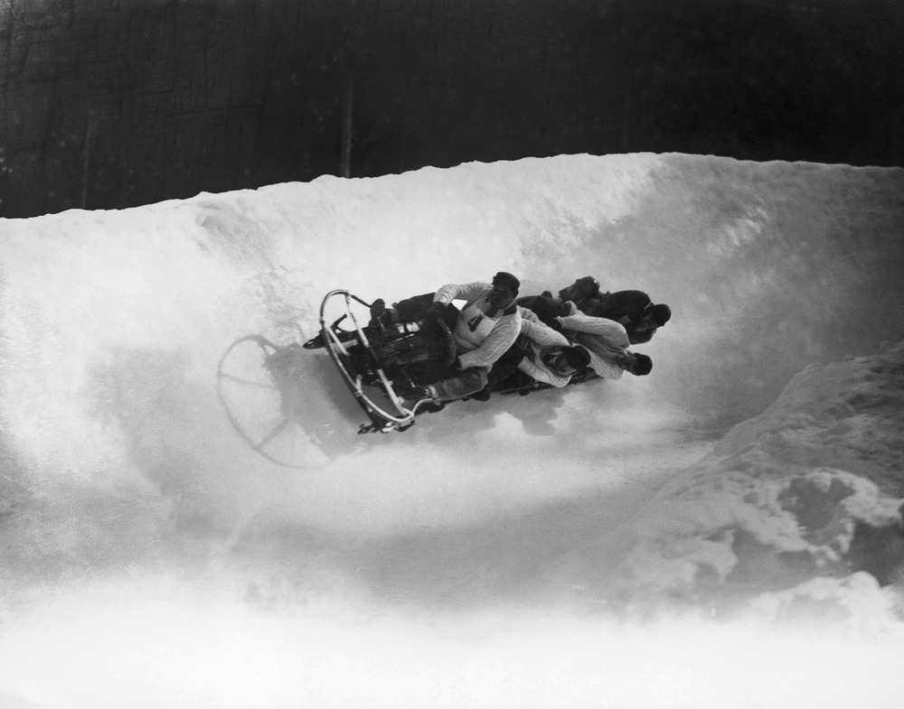 The British four-man bobsleigh team — Ralph Broome, Thomas Arnold, Alexander Richardson and Rodney Soher — is seen in action at the Winter Olympics at Chamonix, France, in February 1924.