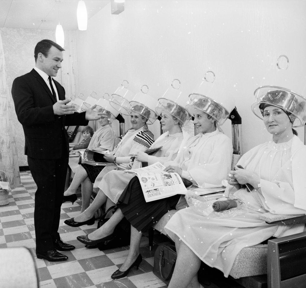 European Lightweight boxing champion, Dave Charnley admiring his clientele at his hairdressing salon in Dartford, 1962