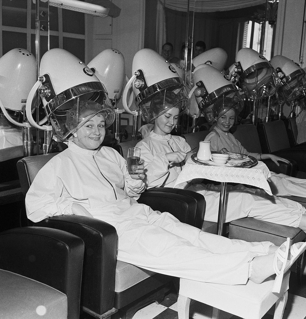 Women Relaxing Under Hair Dryer