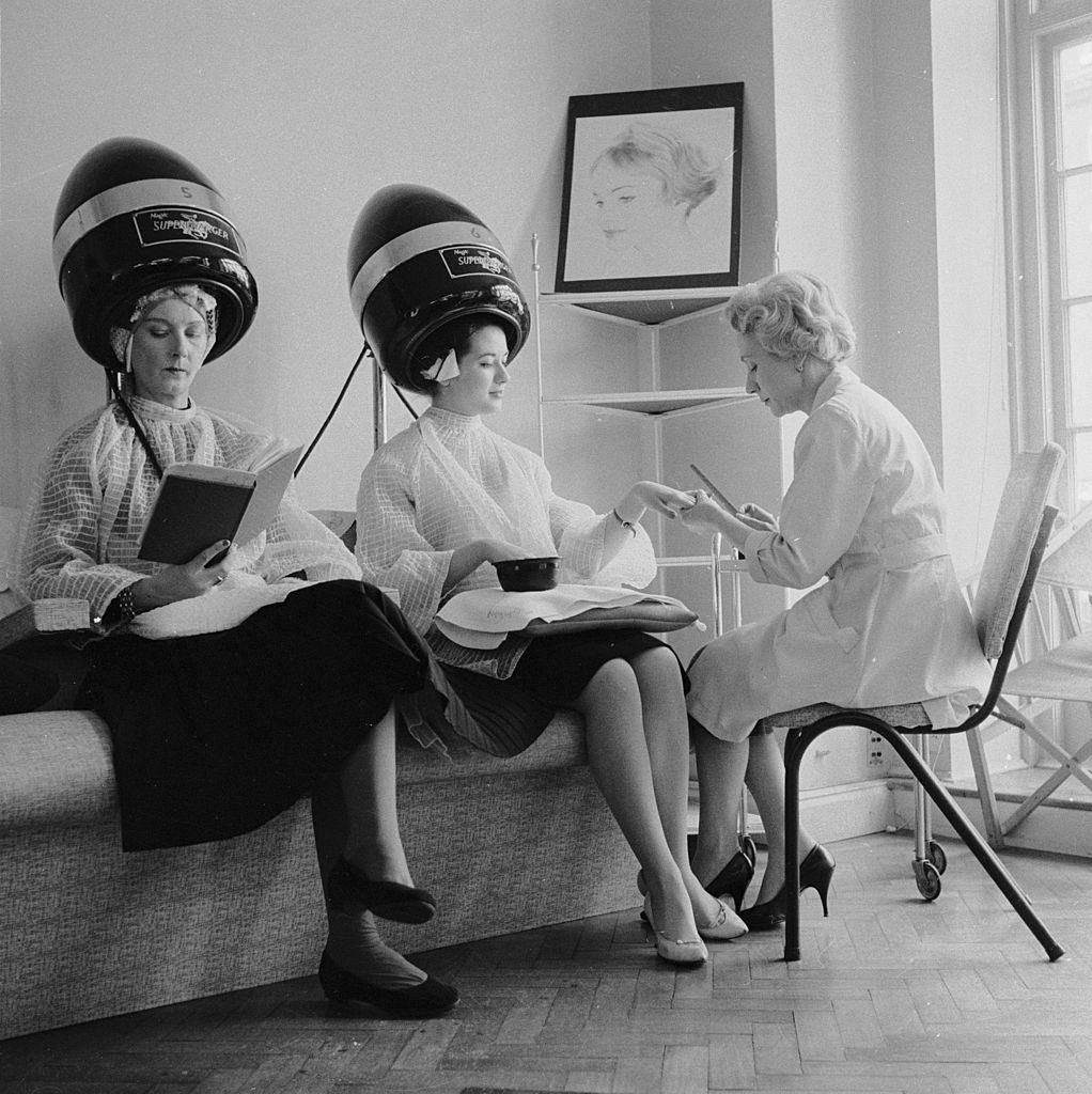 Women enjoy a manicure and hair treatment at the John Douglas School in Mayfair, London, 1959.