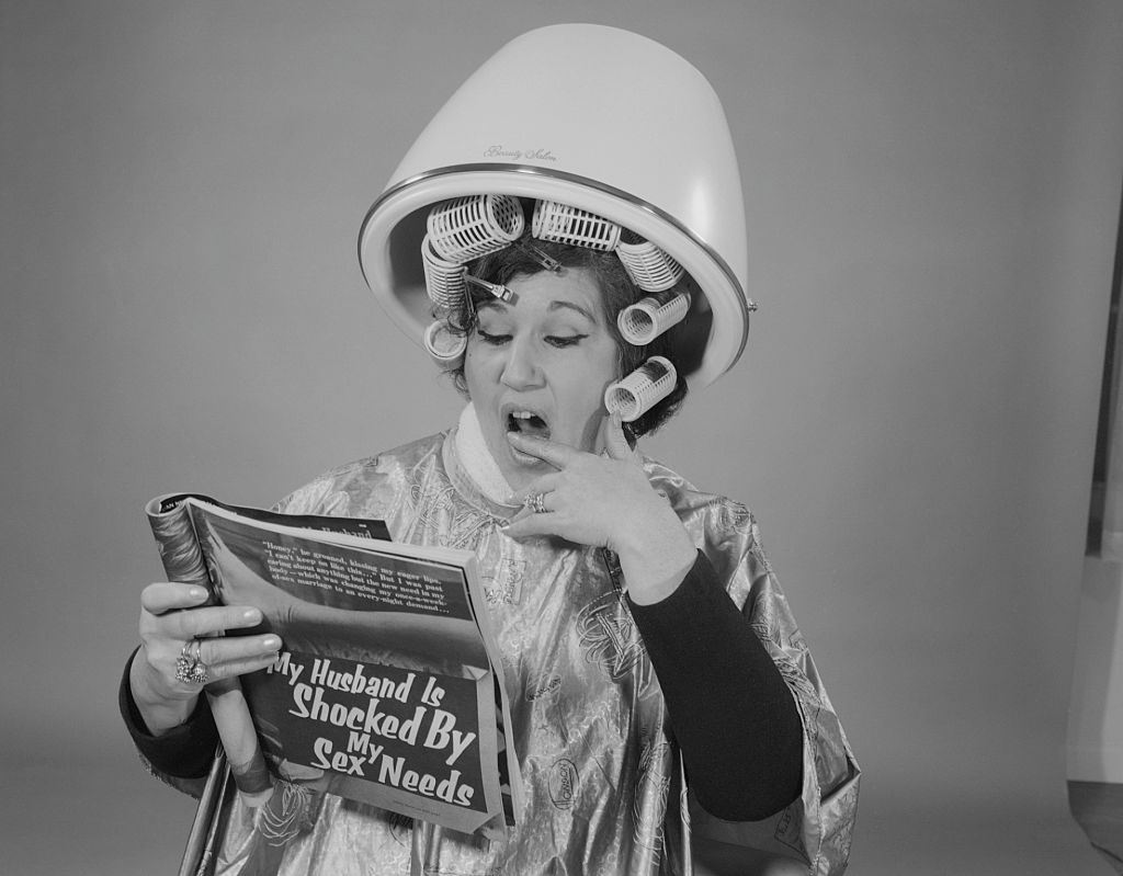 Woman Sitting Under Hair Dryer