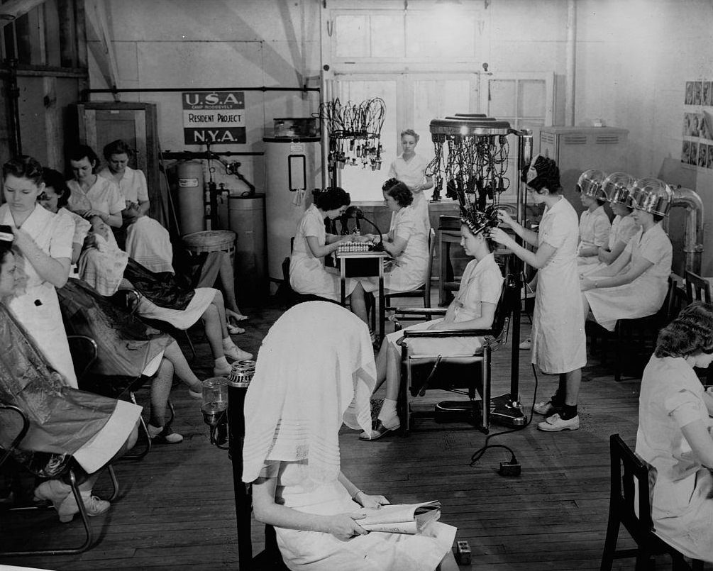 Young women in the National Youth Administration work in a beauty shop to learn beautician skills at Camp Roosevelt in Ocala.