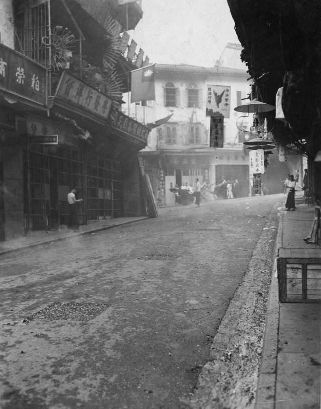 Kowloon Street setting off firecrackers in celebration, August 31, 1945
