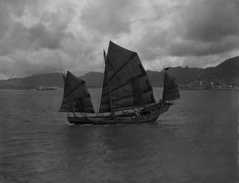 Chinese sampan, H.M.C.S. Ontario in background, Hong Kong, August 31, 1945