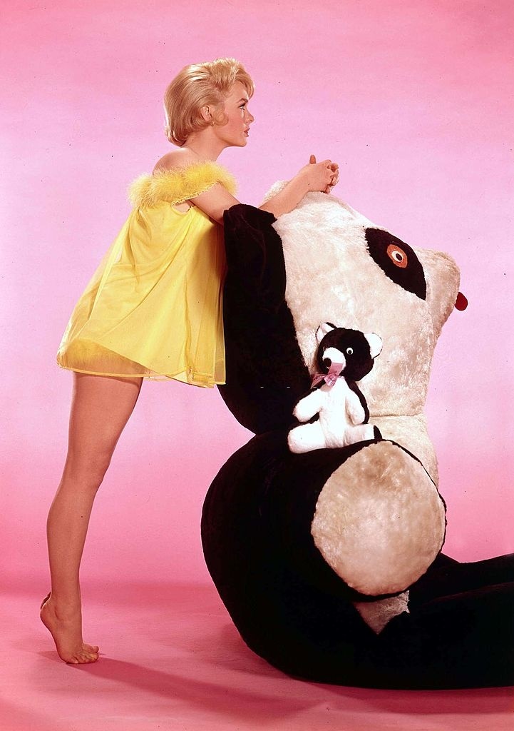 Joey Heatherton dressed in a sexy yellow Teddy, leaning on a giant cuddly Panda, 1960s