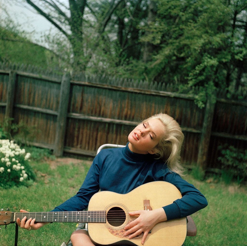 17-years-old, Joey Heatherton playing guitar in her backyard, Rockville Centre, Long Island, New York