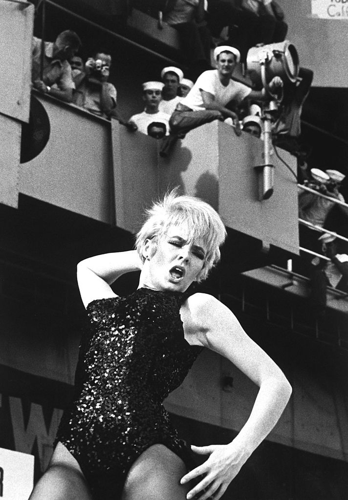 Joey Heatherton entertains the troops on the aircraft carrier USS Ticonderoga with a dance during Bob Hope's USO Christmas show, December 1965