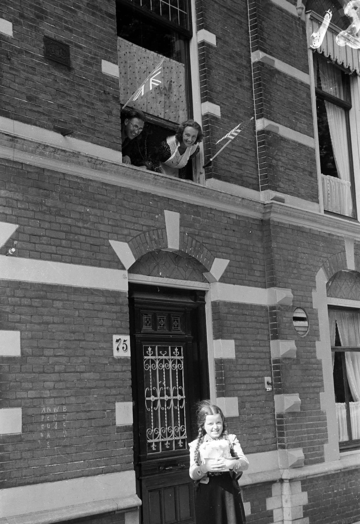 In front of a house, a girl on the street proudly shows a bowl with a lump of butter.