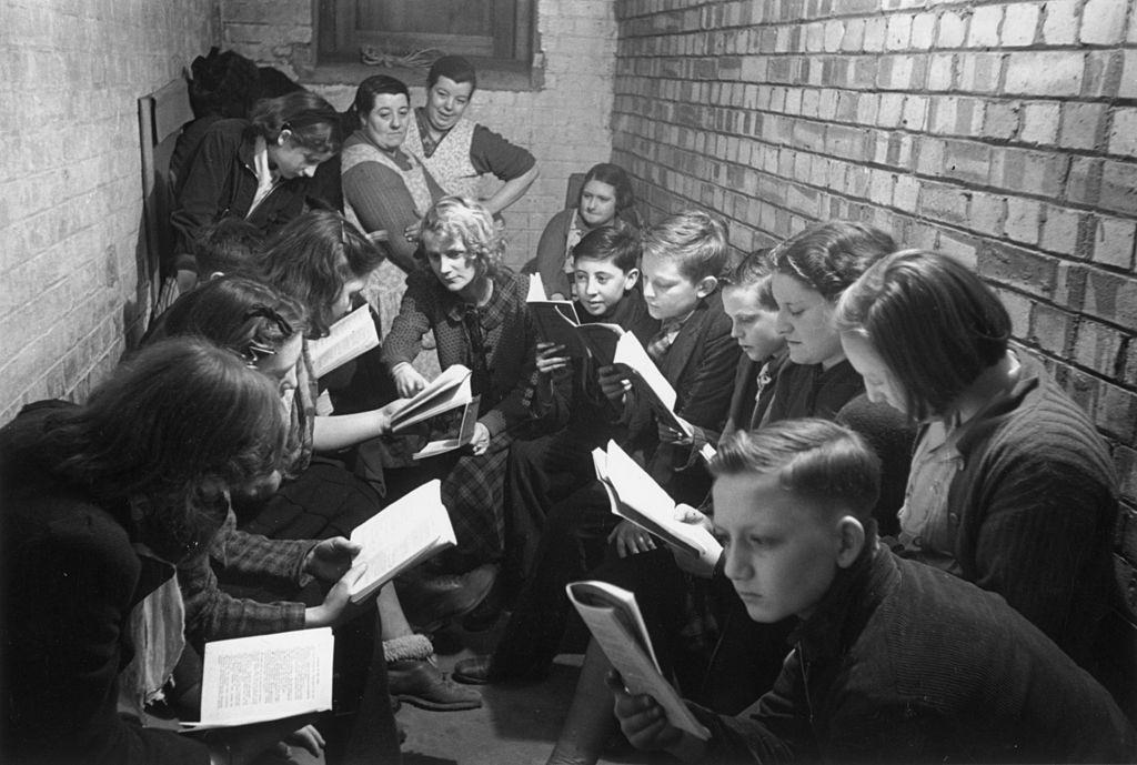 A reading and discussion session in an air raid shelter in Bermondsey, south London, during the Blitz, March 1941.