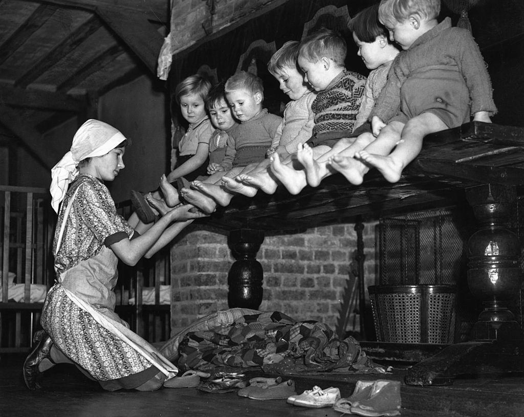A row of toddlers, evacuated from London during the Blitz, have their feet inspected at their new home in a 15th century mansion house in Kent.