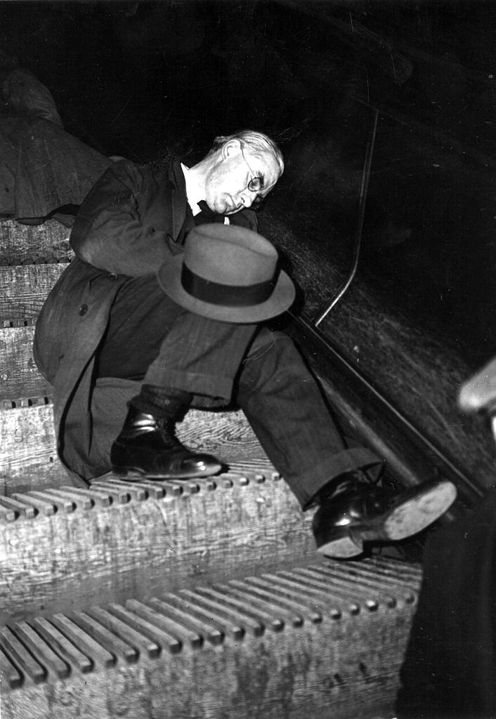 A man sleeping on an escalator in an underground station in London during an air raid.