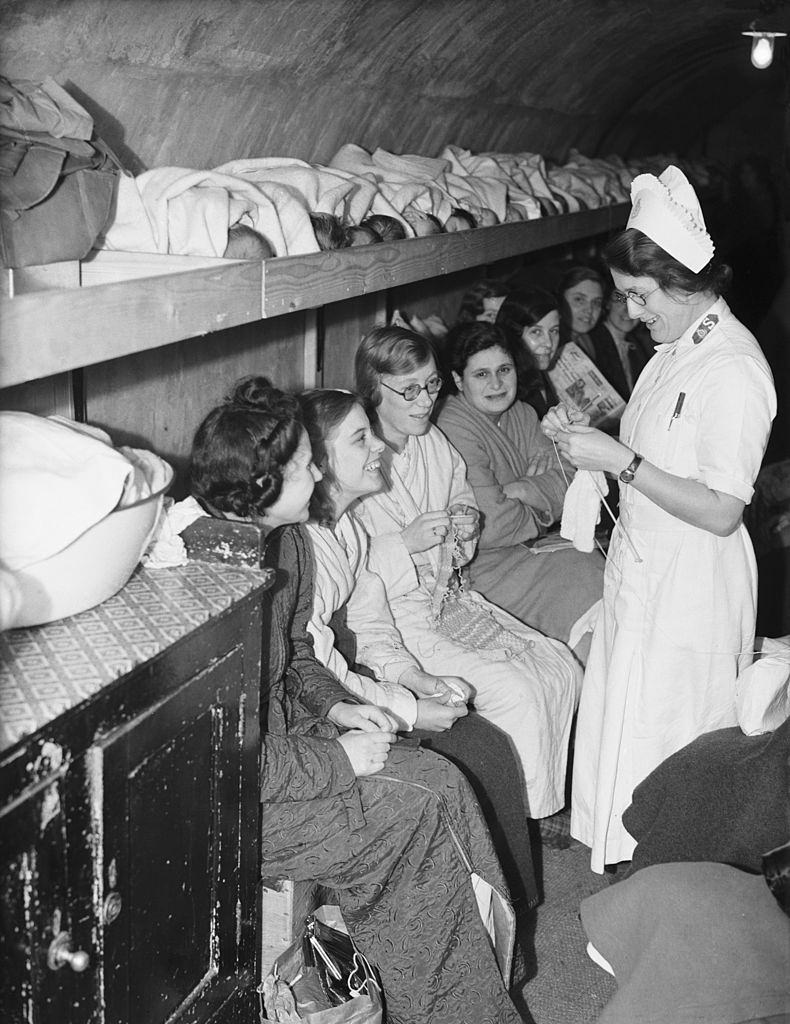 Women, girls and babies (lying on a shelf, top) in an air raid shelter run by the Salvation Army in Clapton, east London, during the London Blitz, 5th October 1940.