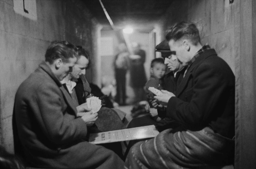 A group of men playing cards in an air raid shelter during the Blitz, London, October 1940.