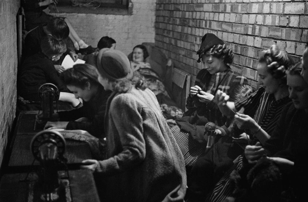Londoners sewing in a craft lesson given by London County Council (LCC) teachers at an air raid shelter in Bermondsey, London during the Blitz, March 1941.