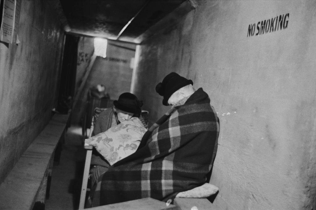 Two elderly women sleeping in an air raid shelter during the Blitz, London, October 1940.