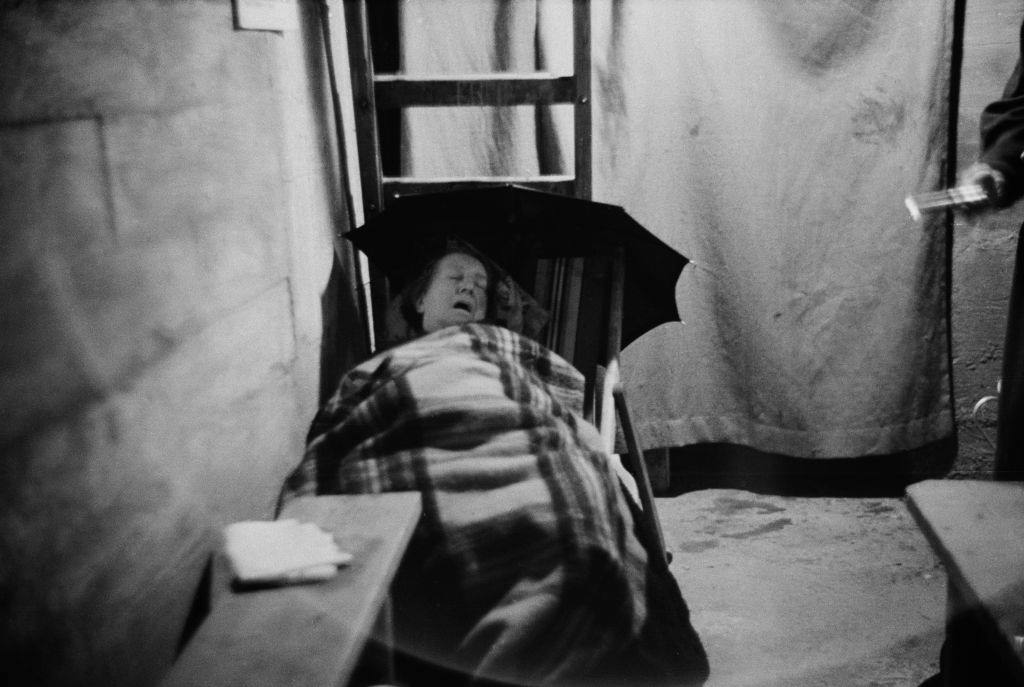 A woman sleeping in an air raid shelter during the Blitz, London, October 1940.