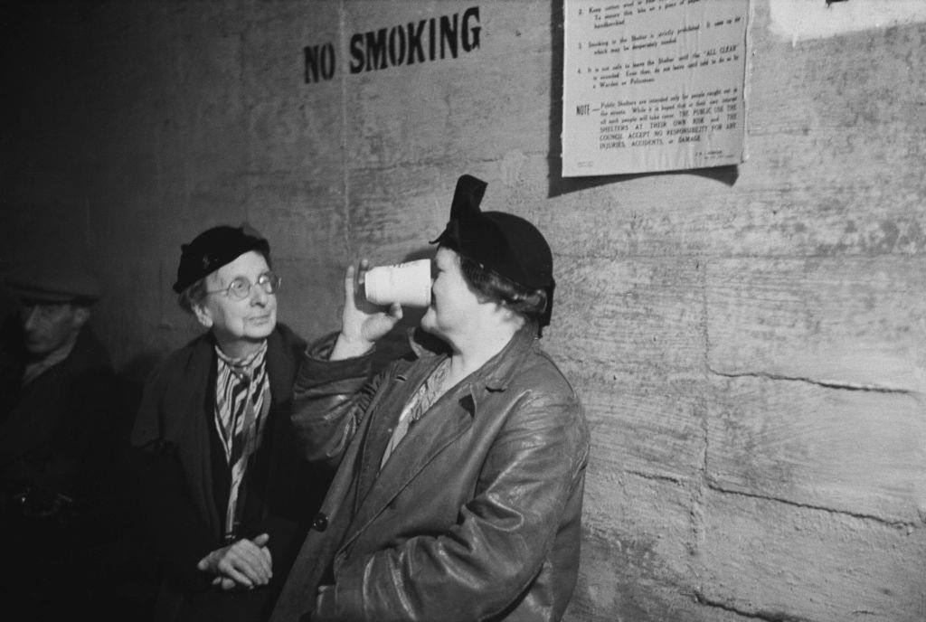 Two women in an air raid shelter during the Blitz, London, October 1940.