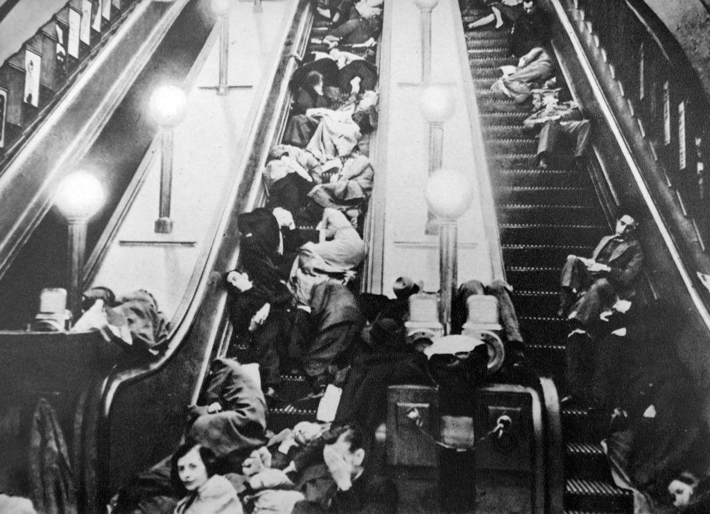 London underground escalators packed with people sheltering from an air raid in world war two 1941.