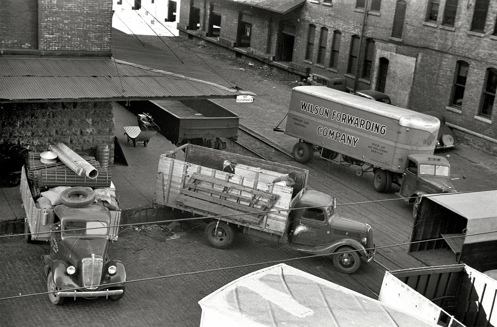 Trucks loading at farm implement warehouse, Minneapolis, Minnesota, September 1939